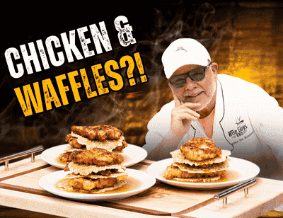 Chef in a white cap/coat poses with two stacks of chicken and waffles on plates, with the bold text “CHICKEN & WAFFLES?!” in the corner.